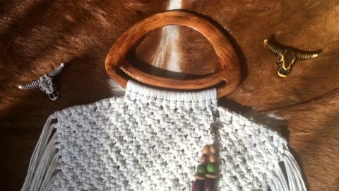 Macrame bag handmade wild west style with wooden pendant. Fashion 4k video. Stock Footage 149700168