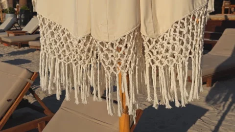Macrame Boho Umbrella with Fringe at Beach Pool Area Stock Footage 339705997