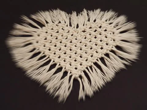 Macrame - a handmade heart made of string Stock Photos