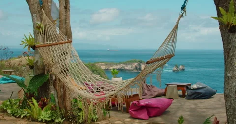 Macrame Rope Hammock Hanging Between Palms Overlooking Turquoise Sea At Nusa Stock-Footage 341293707