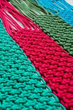 Macrame technique, a square knot of multi-colored threads. Colored macrame st Stock Photos