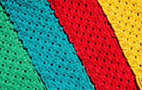 Macrame technique, a square knot of multi-colored threads. Stock Photos