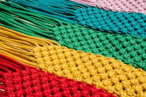 Macrame technique, a square knot of multi-colored threads. Stock Photos