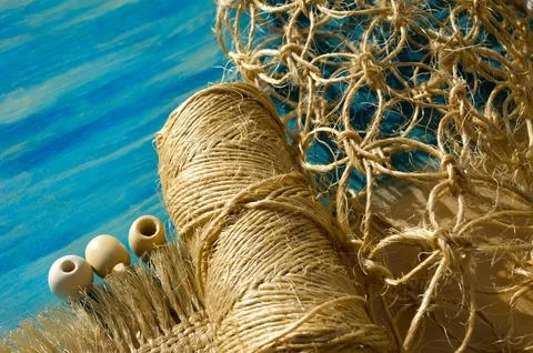 Macrame weaving from straw on a turquoise background. Stock Photos