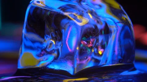 Macro 4K Cube of ice rotating  in neon lighting Stock Footage 106829101