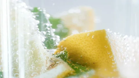 Macro 4k footage of soda bubbles flowing up in glass of fresh cold lemonade Stock Footage 88927215
