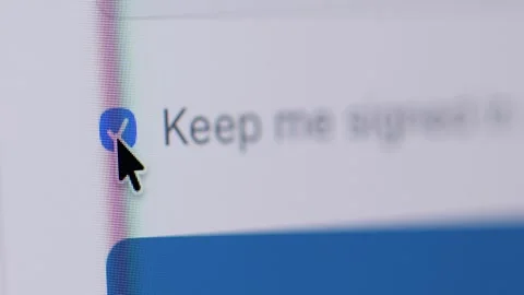 Macro 4K shot of a mouse cursor ticking an empty checkbox for "Keep me signed in Stock Footage 342777958
