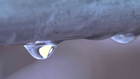 Macro 4k slow motion of dripping raindrop on railing flying in the wind. Stock Footage 104411145