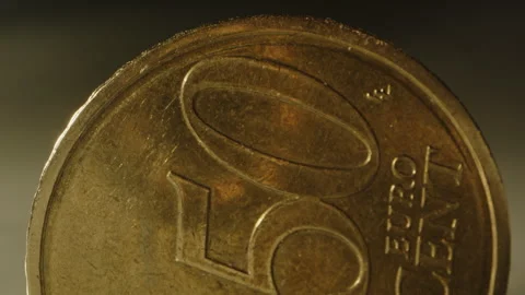 Macro of 50 cent Euro coin standing in a studio. A light moves over the Stock Footage 320621650