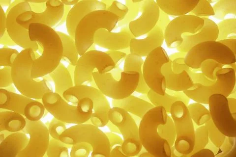 Macro Abstract Backlit Macaroni Pasta With Bright Yellow Glowing Tex Stock Photos