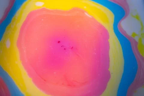 Macro abstract image of layered liquid colors forming a soft pink. Stock Photos