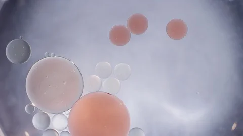 Macro abstract peach and clear liquid bubbles merging texture background Video stock 118279660