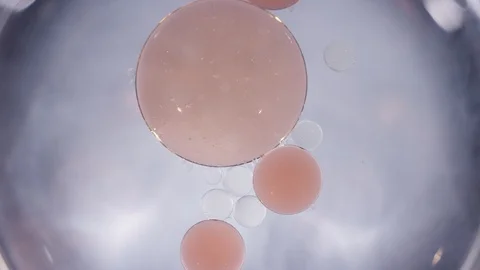 Macro abstract peach and clear liquid cells merging texture background Video stock 118279882