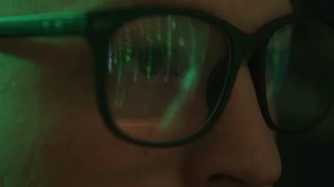 Macro Abstract Shot of Hacker with Glasses Watching Computer Codes on Screen Stock Footage 208797877