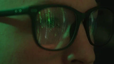 Macro Abstract Shot of Hacker's Glasses Reflecting Computer Codes on Screen Stock Footage 208797791