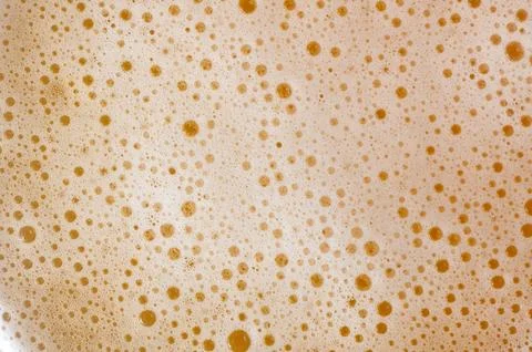 Macro abstract texture of dense beer foam and rising bubbles Stock Photos