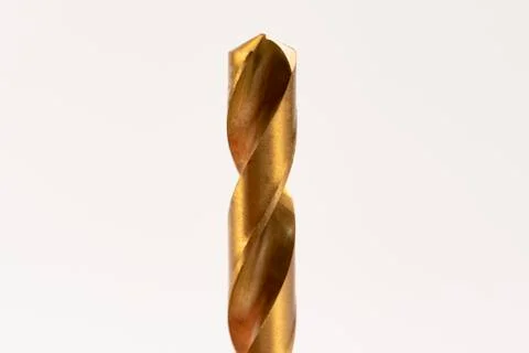 Macro abstract of titanium drill bits on workbench. Stock Photos