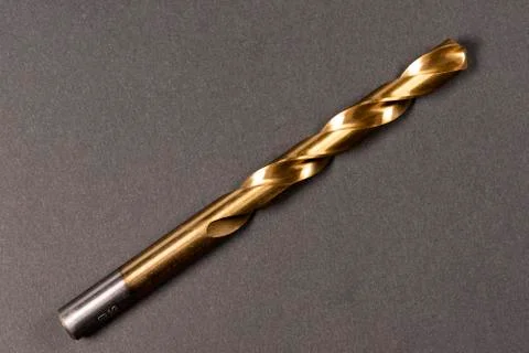 Macro abstract of titanium drill bits on workbench. Stock Photos