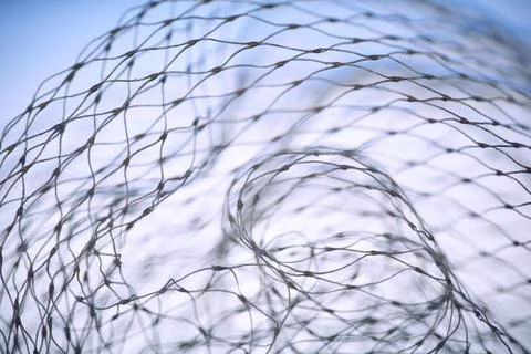 Macro abstract of a white nylon net against a soft blue sky. Intricate patter Stock Photos