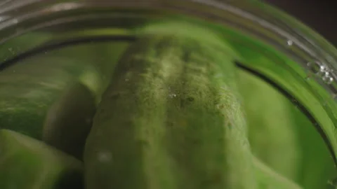 Macro, Air Bubbles Rise from Cucumber Jars for Marinade Making Filled with Stock Footage 157679045