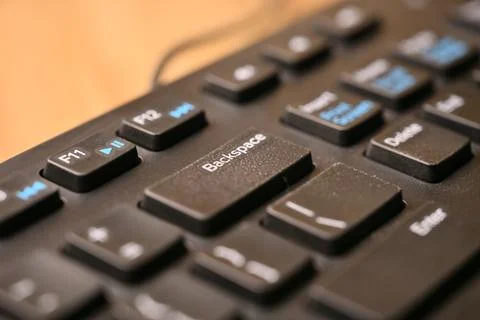 Macro Angled Top View Black Computer Keyboard Highlighting Backspace Key on.. Stock Photos