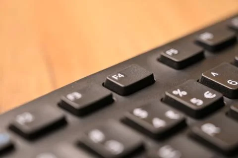Macro Angled Top View Black Computer Keyboard Highlighting F4 Function Key .. Stock Photos