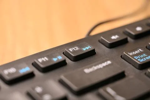 Macro Angled Top View Black Computer Keyboard Highlighting F12 Function Key.. Stock Photos