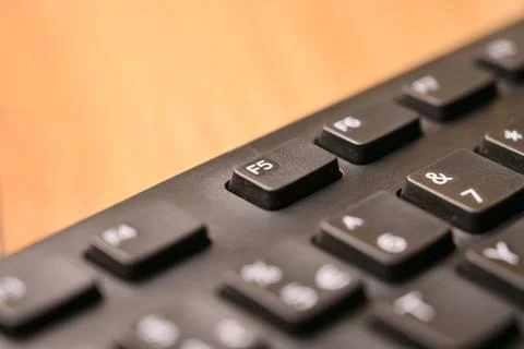 Macro Angled Top View Black Computer Keyboard Highlighting F5 Function Key .. Stock Photos