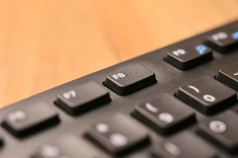 Macro Angled Top View Black Computer Keyboard Highlighting F8 Function Key .. Foto stock