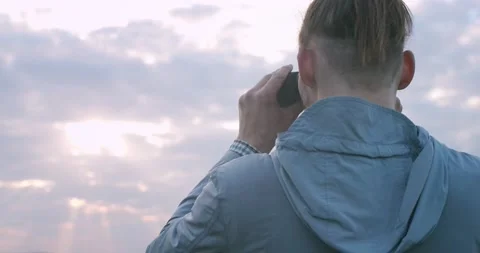 Macro back portrait of stylish man looking into binoculars to horizon handheld Stock Footage 135211911