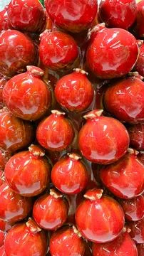 Macro background of sweet red glazed pomegranates with a vibrant glossy tex.. 库存照片