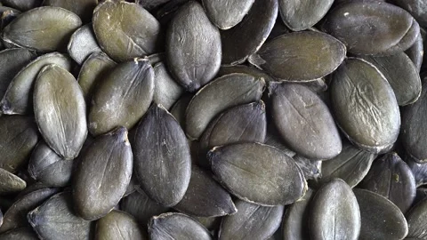 Macro background texture of green pumpkin seeds, rotate Stock Footage 149371355