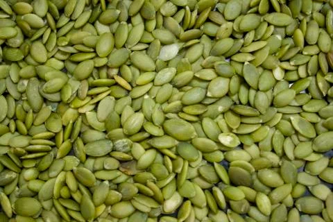 Macro background texture of green pumpkin seeds Stock Photos