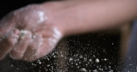 Macro of baker sprinkles flour on dough while making bread or pizza in bakery Stock-Footage 269332559