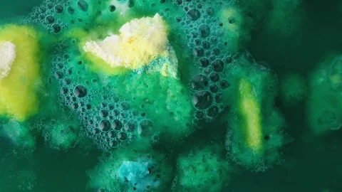 Macro bath bomb in water with bubbles, top view. Concept of green toxic Stock Footage 121029957