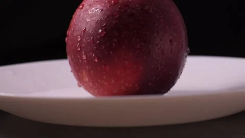 Macro, beautiful red apple on a black background Stock Footage 186987300