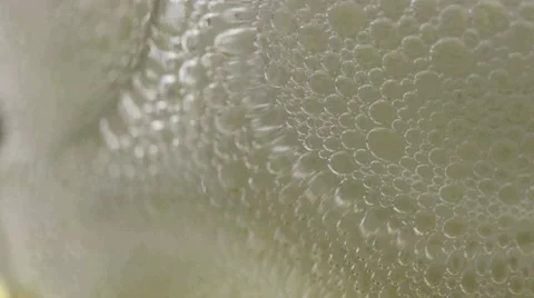 Macro beer foam bubbles popping Stock Footage 68002617