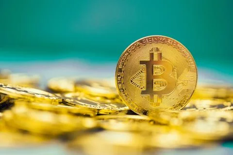 Macro of a bitcoin on an aqua bitcoin background Fotos de archivo