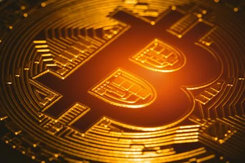 Macro bitcoin front face with warm glow. virtual cryptocurrency concept. Stock Photos