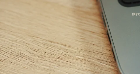Macro of the black flash card being putted in the laptop computer on the wooden Stock Footage 86434867