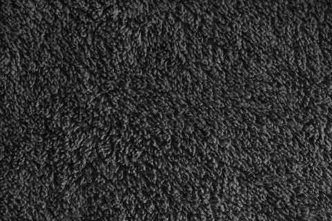 Macro of black microfiber bath towel, soft fluffy fabric, absorbent materia.. Stock Photos