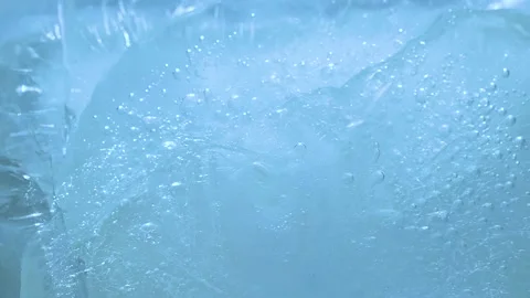 Macro blue broken ice texture background with splashing water surface and ripple Stock Footage 231394250