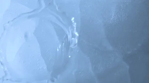Macro blue broken ice texture with splashing water surface, drops and ripples Vídeo Stock 234683281