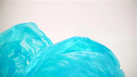 Macro of blue plastic bags on white background isolated Stock Footage 328962817