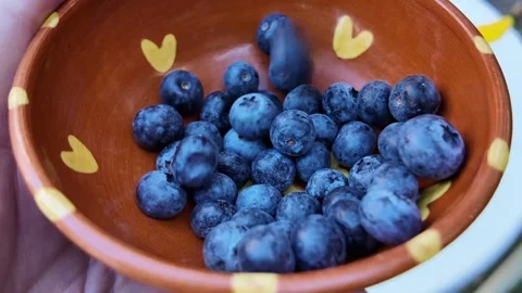 Macro blueberries falling into a bowl Stock Footage 346898397