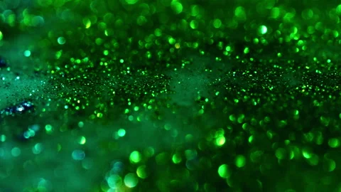Macro bokeh of shimmering glitter particles in vibrant fluid motion Stock Footage 331743435