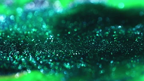 Macro bokeh of shimmering glitter particles in vibrant fluid motion Stock Footage 331744580