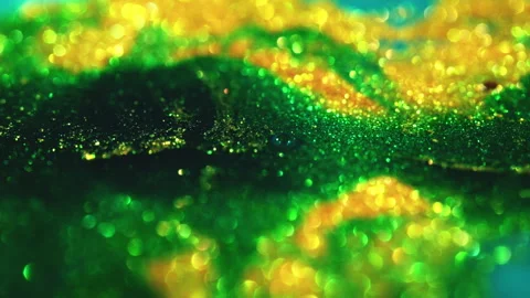 Macro bokeh of shimmering glitter particles in vibrant fluid motion Stock Footage 331745607