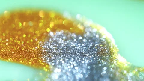 Macro bokeh of shimmering glitter particles in vibrant fluid motion Stock Footage 331746984