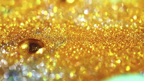Macro bokeh of shimmering glitter particles in vibrant fluid motion Stock Footage 331747161